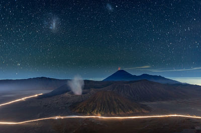 View of volcanic mountain against star field