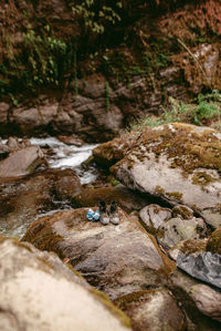 Surface level of stream flowing through rocks in forest