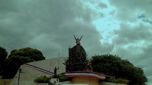 Low angle view of statue against cloudy sky