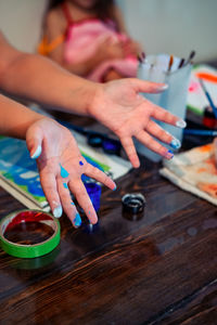 High angle view of woman hand on table