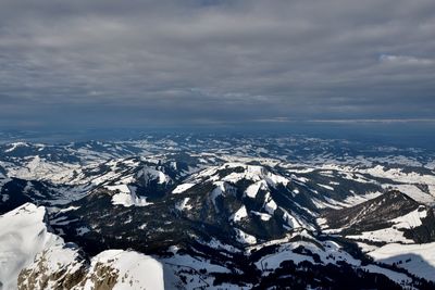 Aerial view of snowcapped mountains against sky