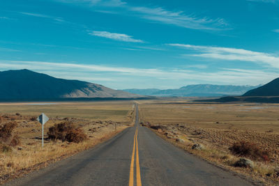 Road by landscape against sky