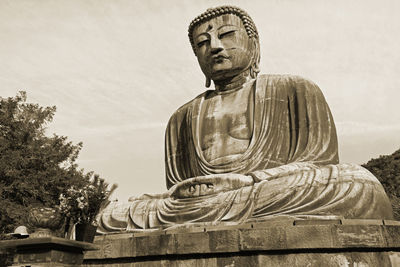 Low angle view of statue against sky