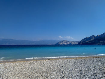 Scenic view of sea against blue sky