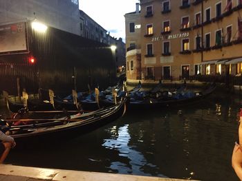 Boats moored in canal in city