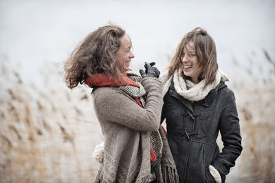 Mother and teenage daughter at water