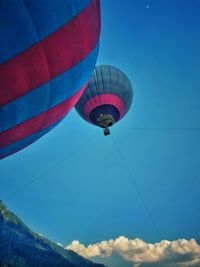 Low angle view of hot air balloon against blue sky