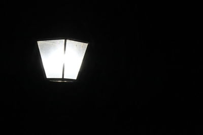 Low angle view of illuminated electric lamp