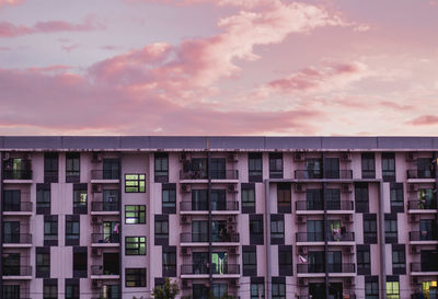 Buildings in city against sky during sunset