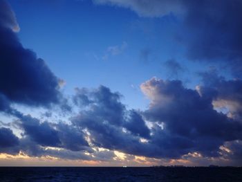 Low angle view of sea against dramatic sky