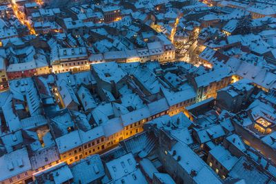 High angle view of illuminated buildings in city during winter