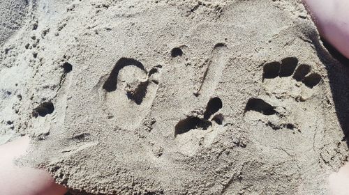 High angle view of footprints on sand at beach