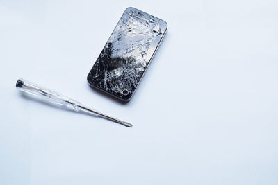 High angle view of fork on table against white background