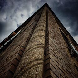 Low angle view of building against cloudy sky