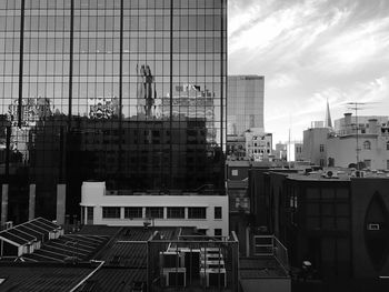 Reflection of city on cloudy sky