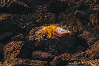 Woman relaxing on rock