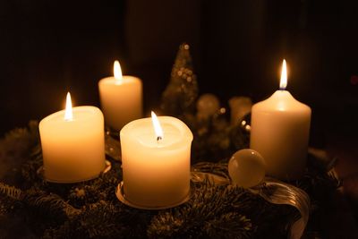 Close-up of illuminated candles on table