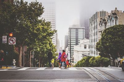 People crossing street in city