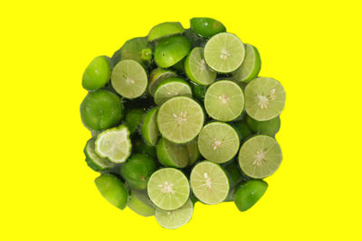 Close-up of green chili peppers against yellow background