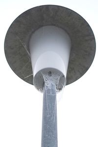 Low angle view of communications tower against sky