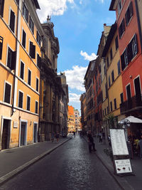 Street amidst buildings in city against sky