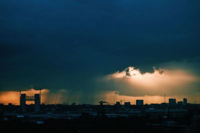 Silhouette cityscape against sky during sunset