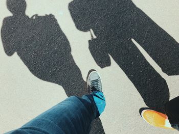 Low section of people standing on road