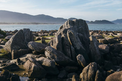 Rocks on beach against sky