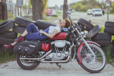 Girl auto mechanic lies on a motorcycle