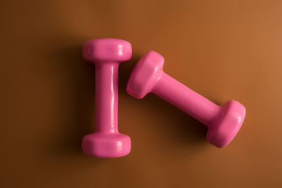 Close-up of pink candle against colored background