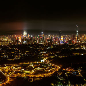 Aerial view of illuminated buildings in city at night