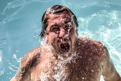 Close-up of man swimming in pool