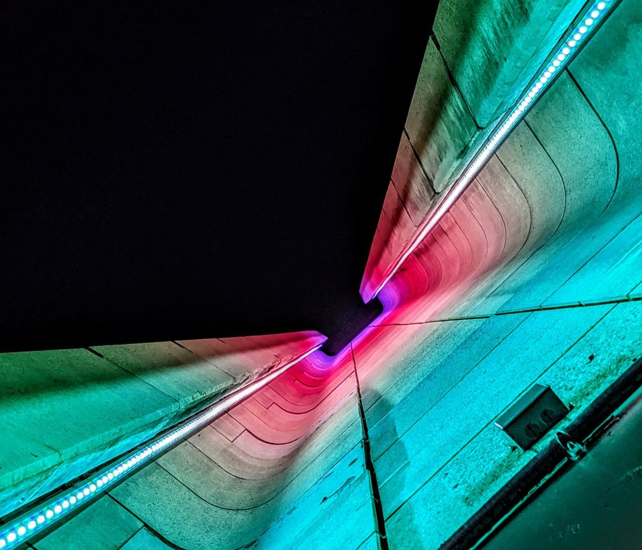 no people, multi colored, indoors, architecture, copy space, night, close-up, illuminated, high angle view, transportation, red, blue, built structure, nature, lighting equipment, wall - building feature, motion, turquoise colored