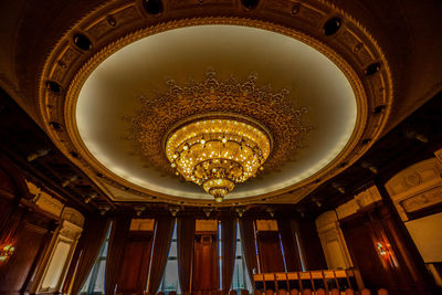 Low angle view of illuminated chandelier in building