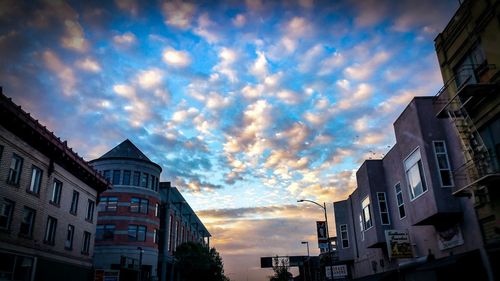 Buildings against cloudy sky at sunset