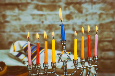 Close-up of lit candles on table