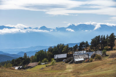 Scenic view of trees and mountains against sky