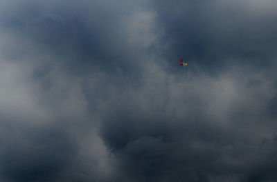 Low angle view of helicopter flying in sky