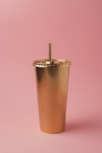 Close-up of drink against pink background