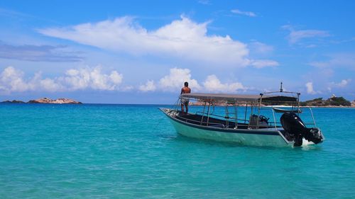 View of boat in sea against cloudy sky