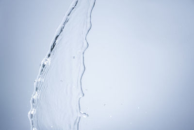Close-up of water falling against gray background