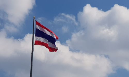 Low angle view of flag against sky