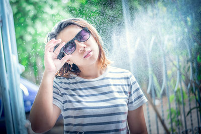 Portrait of smiling girl standing against plants