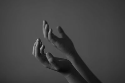 Close-up of woman hand against gray background
