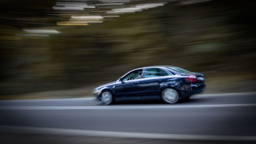 Close-up of car on road