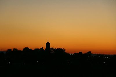 Silhouette of built structure at sunset