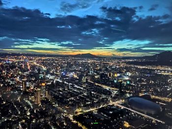 High angle view of illuminated city buildings against sky