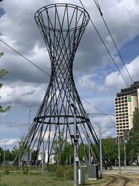 Low angle view of metallic structure on field against sky