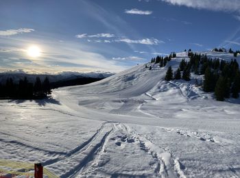 Snow covered landscape against sky