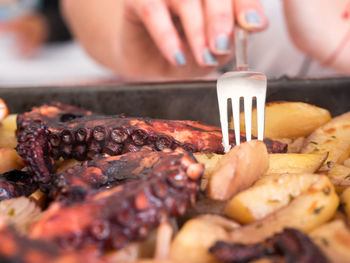 Close-up of preparing food on barbecue grill
